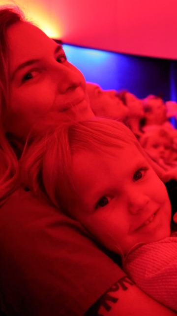 Mother and daughter sitting inside flandrau planetarium in tucson
